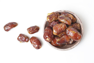 Dried dates in small bowl - studio shoot on the white