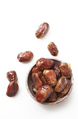 Dried dates in small bowl - studio shoot on the white