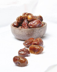 Dried dates in small bowl - studio shoot on the white