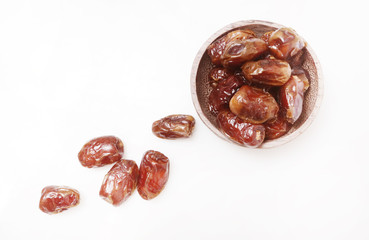Dried dates in small bowl - studio shoot on the white