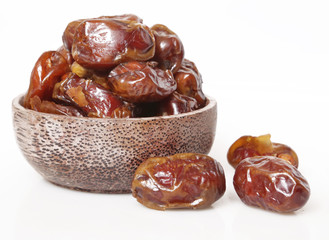 Dried dates in small bowl - studio shoot on the white