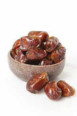 Dried dates in small bowl - studio shoot on the white
