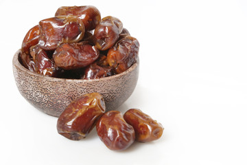 Dried dates in small bowl - studio shoot on the white