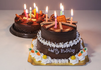 chocolate cake with happy birthday light candle