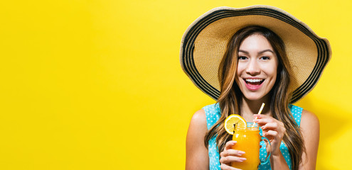 Happy young woman drinking smoothie