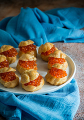 Profiteroles stuffed with red caviar
