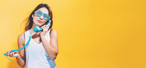 Young woman talking on old fashion phone