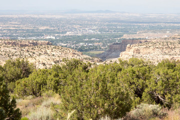 Fototapeta na wymiar View of Farmington, New Mexico through canyon and pinions on the Navajo reservation