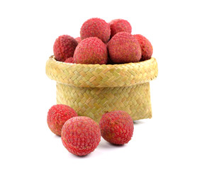 Lychees in a wicker basket on a white background.