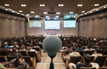 Microphone over the Abstract blurred photo of conference hall or seminar room with attendee background, Business meeting concept - obrazy, fototapety, plakaty