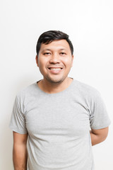 Smiling Asian man in gray t-shirt