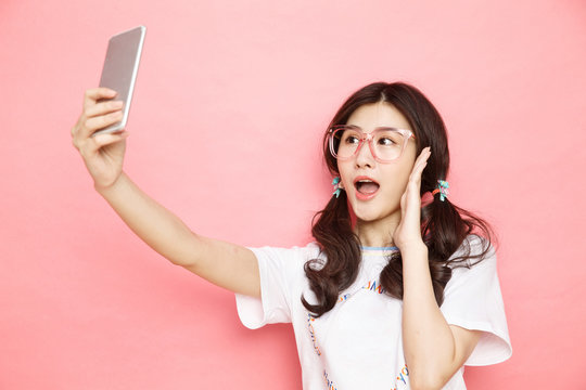 Young girl with a mobile phone self timer