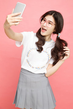 Young girl with a mobile phone self timer