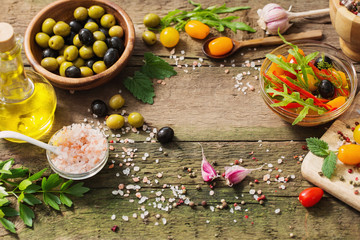 vegetables and olives on old wooden background