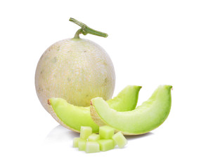 green cantaloupe melon with slice and cubes isolated on white background