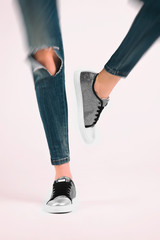 Girl in jeans and silver sneakers