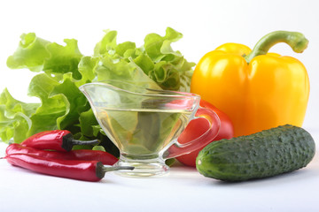 Assorted vegetables, fresh bell pepper, tomato, chilli pepper, cucumber, olive oil and lettuce isolated on white background. Selective focus.
