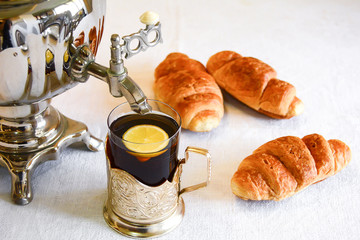 Tea from a samovar with croissants. Selective focus