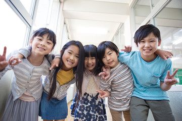 Obraz premium 廊下で肩を組む小学生