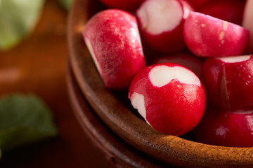 Fresh radishes in wooden bowl