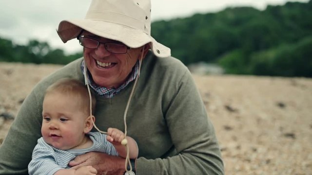Grandfather playing with his grandchild on the beach