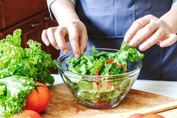 Woman cooking mixing salad