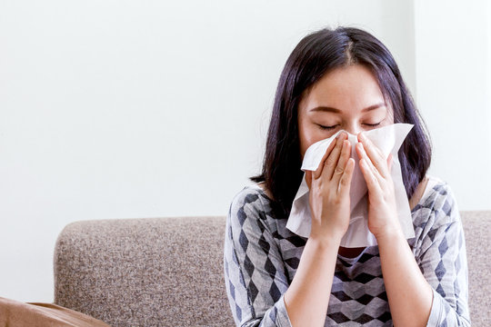 Sick Woman Blowing Her Nose With Tissues