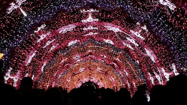Moscow street is decorated with an arch of lighting and lights for New Year and Christmas holidays. The townsfolk are under a luminous arch. Pushkin Square. New Year theme.