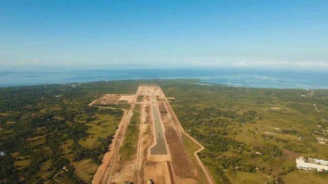 Construction of a new airport terminal on Panglao. Aerial view Modern airport terminal construction site. Construction of a landing strip on the island of Bohol, Philippines. Landing strip. 4K video