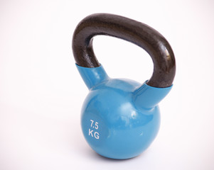 Fototapeta na wymiar blue kettlebell with black handle.7.5 kilograms
