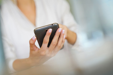 Closeup of woman' s hand using smartphone
