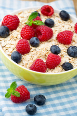 Oatmeal porridge with berries. Raspberries and blueberries.