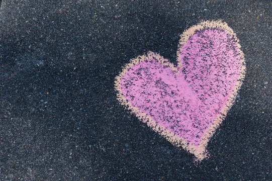 Heart drawn with colourful chalks on asphalt. Love concept.