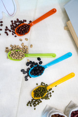Variety of beans in colorful spoon