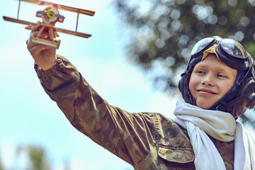 Happy child dreams of becoming a pilot.