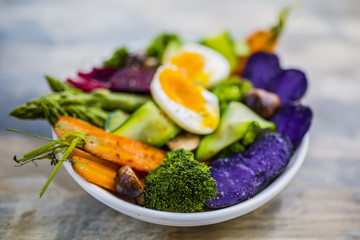 Delicious and healthy salad with colorful vegetables and egg. Rainbow food.
