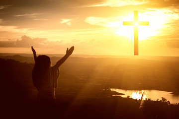 Girls raise their arms up the sky Worship god on the mountain cross