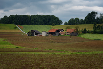 Rural alpine landscape with slovenian village in valley near Bled lake at spring sunny day. Slovenia.