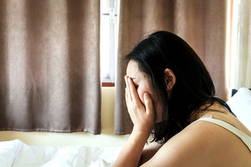 Depressed woman crying on her bed