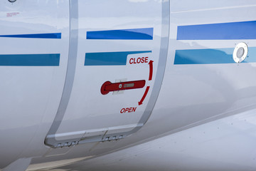 Airplane door with text open and close. 