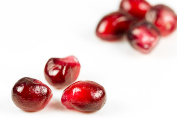 fresh and peeled pomegranate seed on white background