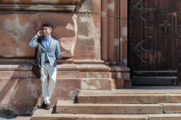 Happy smiling male person using smartphone for talk © Yakobchuk Olena