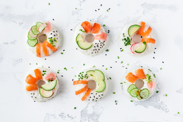 Sushi donuts set on white background. Sushi trend. Creative food. Flat lay, top view