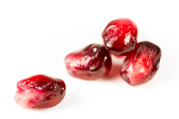 fresh and peeled pomegranate seed on white background