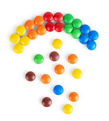 Colorful delicious chocolate candies are lying in several rows, forming a square. Sweets are sorted by color. Festival and happiness concept. Isolated on a white background