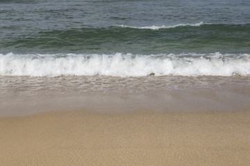 Fototapeta na wymiar Wave on the sand beach in Thailand sea.