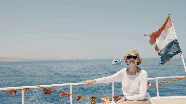 Woman enjoying a trip on yacht sitting on deck, Egypt