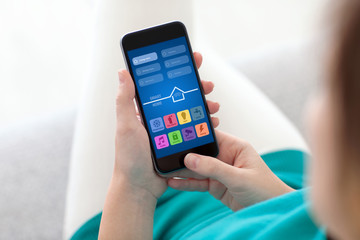 woman holding phone with app smart home on screen