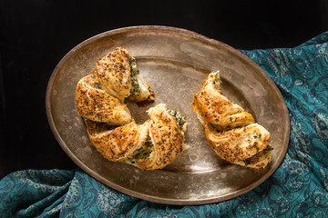 Greek pie spanakopita with spinach, cheese. Simple dark background. Healthy food. Lifestyle.