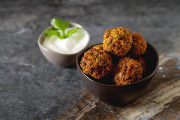 Middle Eastern traditional dishes. Falafel with sour cream. Vegetarian food.